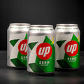 Three 7-up Zero Sugar cans on a black background