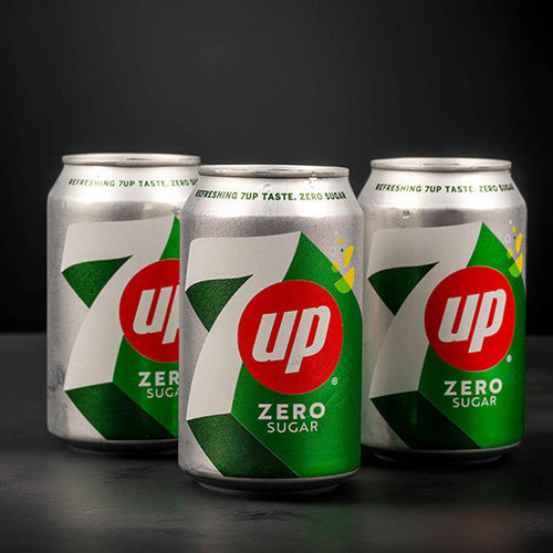 Three 7-up Zero Sugar cans on a black background